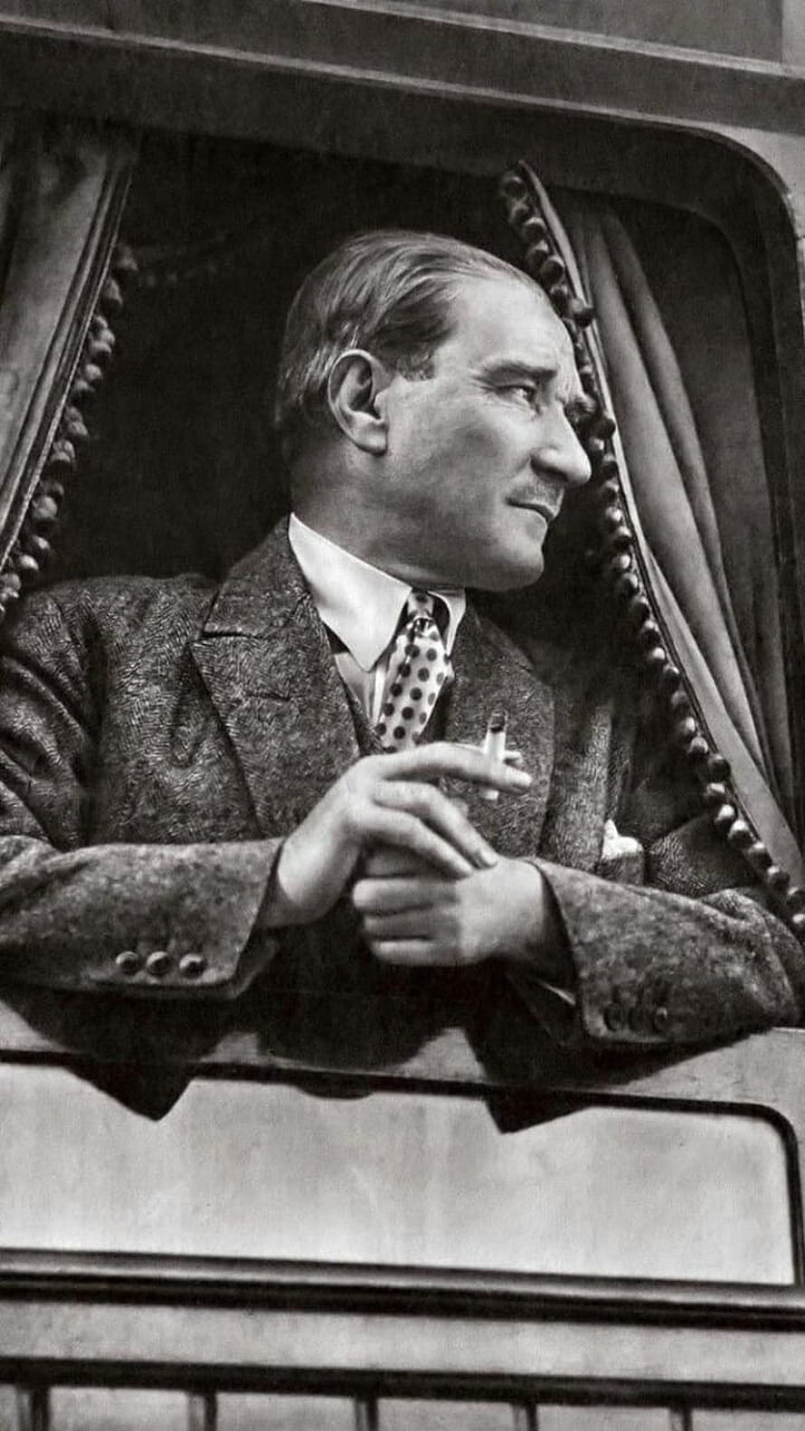 Mustafa Kemal Ataturk in a tweed suit holding a cigarette in a vintage black and white portrait HD phone wallpaper