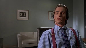 Christian Bale as Patrick Bateman in American Psycho listening to music with headphones in office, Patrick Bateman HD wallpaper