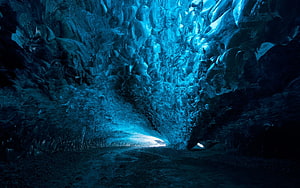 Mystical Blue Ice Cave Tunnel With Glowing Crystalline Walls And Bright Exit HD wallpaper
