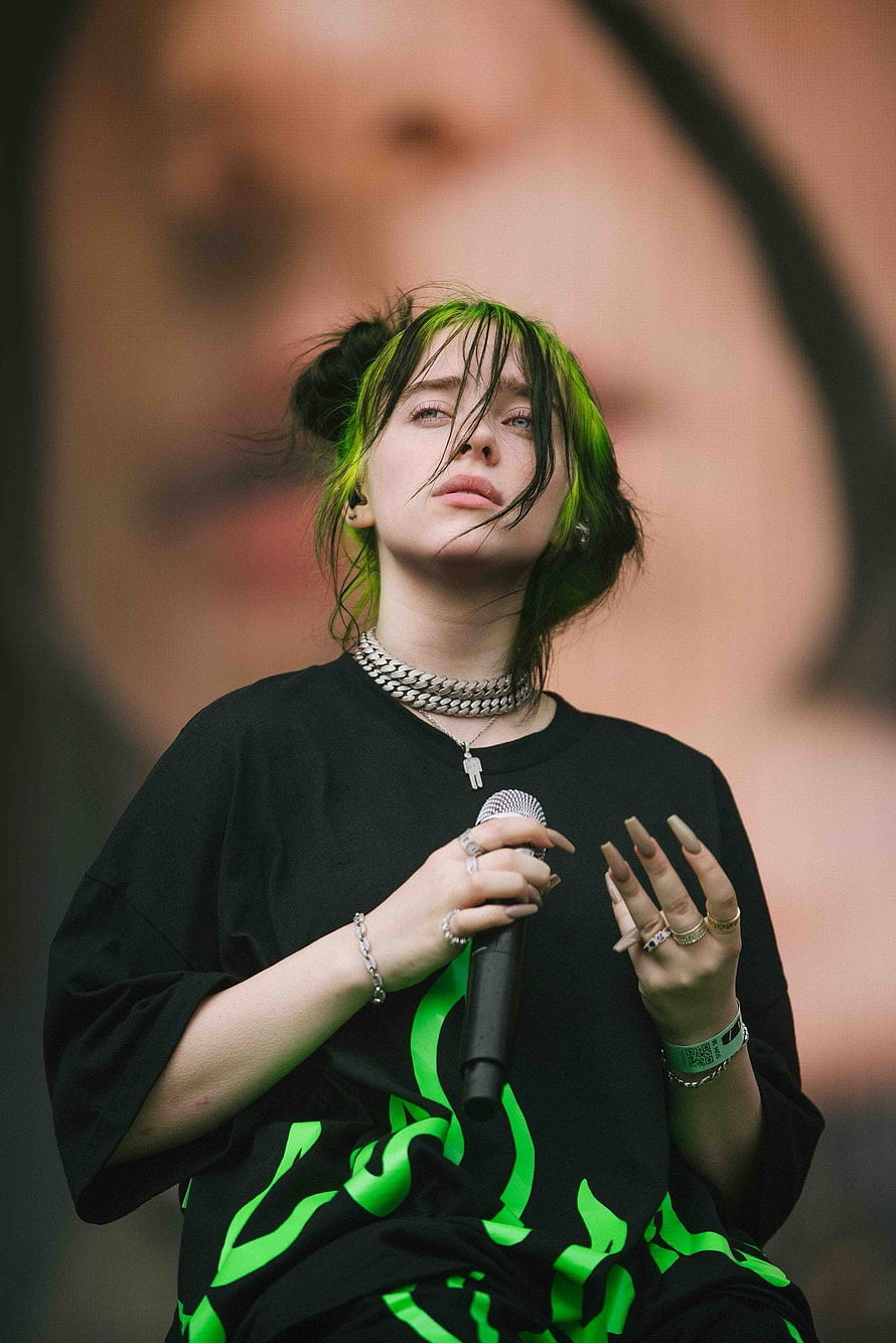 Billie Eilish performing live on stage with green hair and microphone HD phone wallpaper