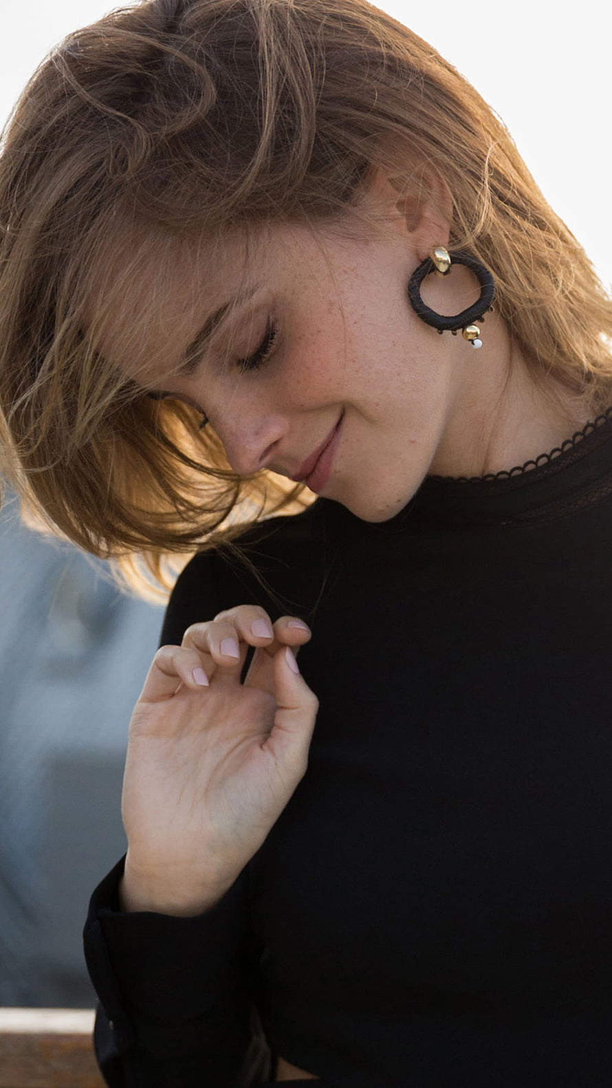 Emma Watson in a black top with statement hoop earrings, soft natural light portrait HD phone wallpaper