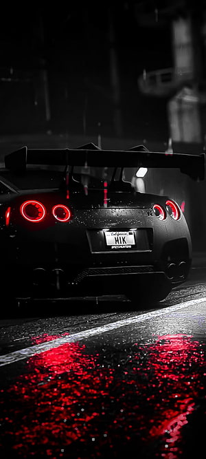 Nissan GT-R R35 Rear View in Rain with Glowing Red Taillights and Wet Asphalt Reflections HD phone wallpaper