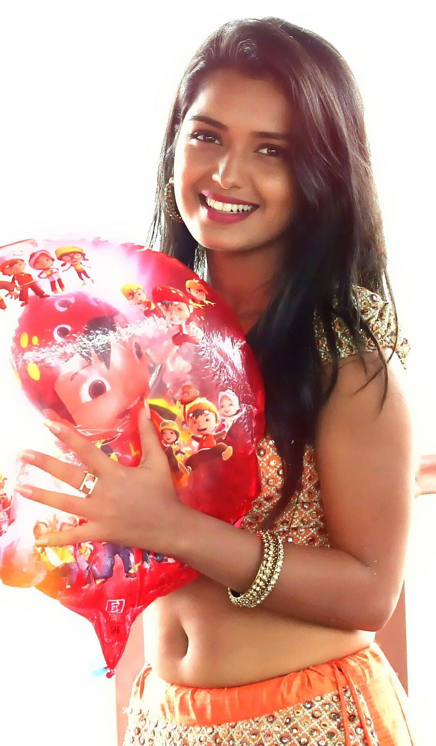 Nayanthara smiling while holding a red balloon with cartoon characters HD phone wallpaper