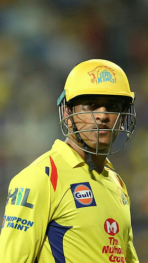 MS Dhoni in Chennai Super Kings yellow cricket kit with helmet and sponsor logos HD phone wallpaper