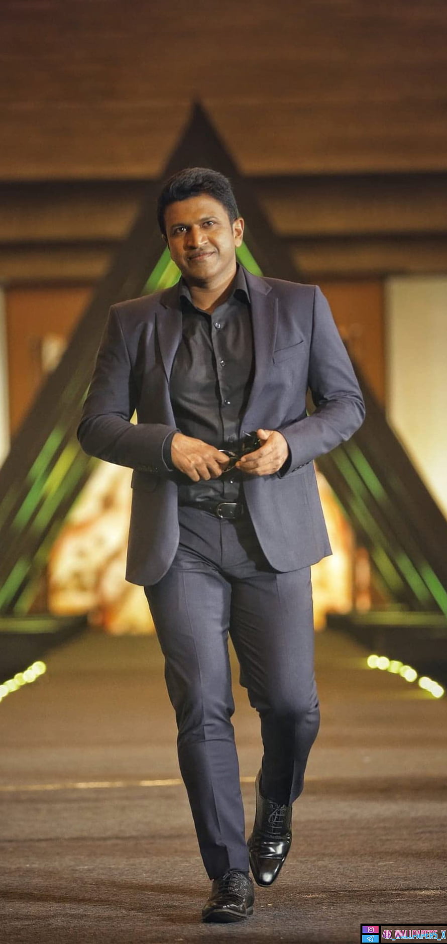 Dhanush in a stylish grey suit walking confidently with a blurred background HD phone wallpaper