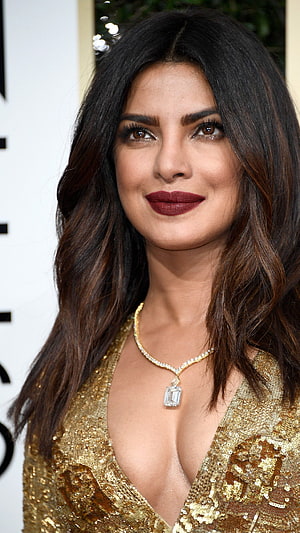Priyanka Chopra in a glamorous gold sequin dress with a diamond necklace HD phone wallpaper