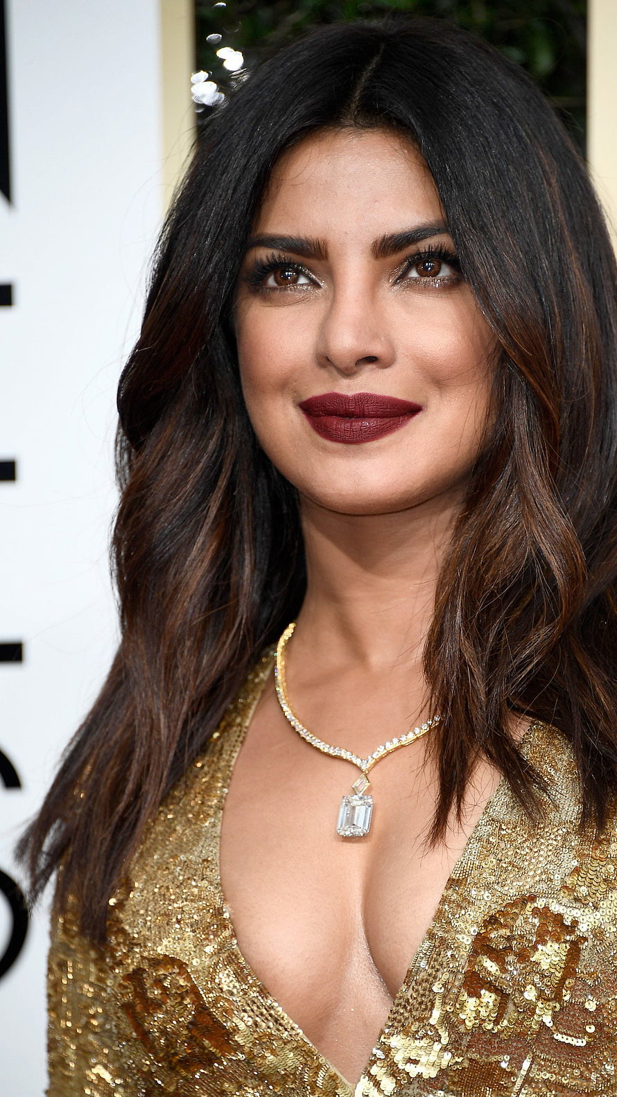 Priyanka Chopra in a glamorous gold sequin dress with a diamond necklace HD phone wallpaper