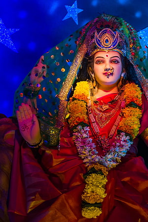 Vaishno Devi Matrika adorned in vibrant red attire with floral garlands and ornate jewelry HD phone wallpaper