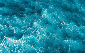 Aerial View of Turquoise Ocean Waves with White Sea Foam and Deep Blue Water Texture HD wallpaper
