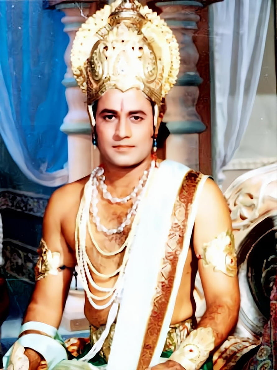 Arun Govil as Shri Ram in ornate royal costume with golden crown and pearl necklaces HD phone wallpaper