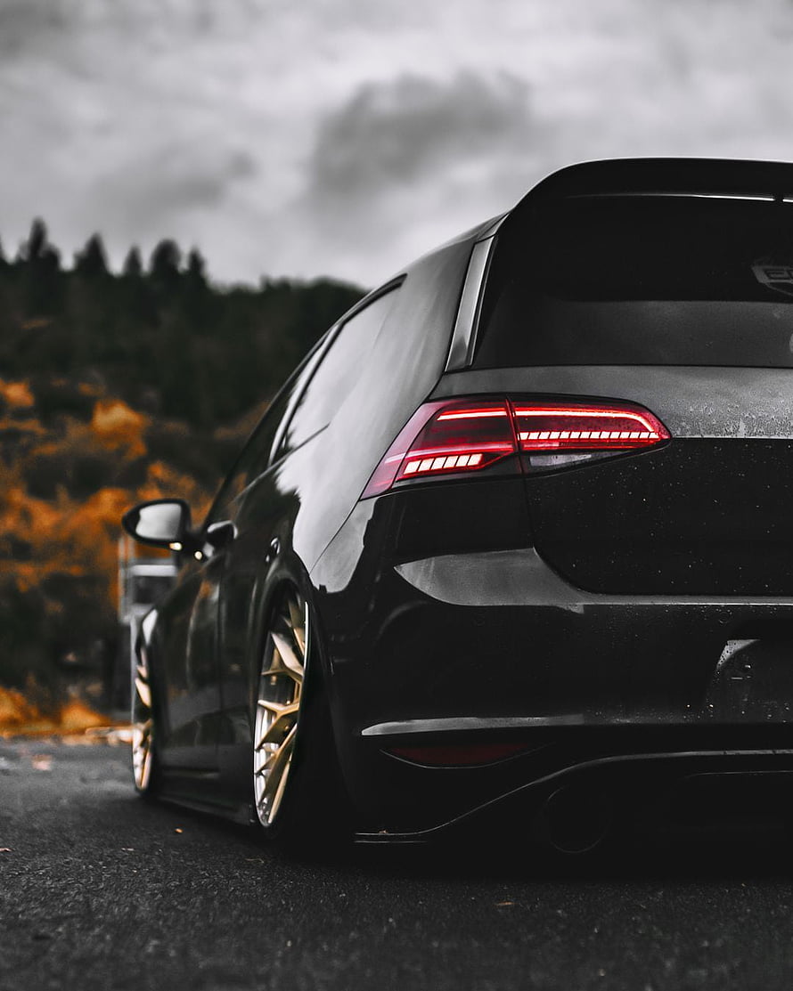 Black Volkswagen Golf R with Gold Wheels on a Rainy Road HD phone wallpaper