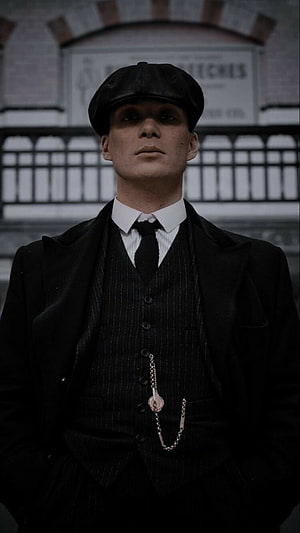 Tommy Shelby from Peaky Blinders in black suit and flat cap HD phone wallpaper