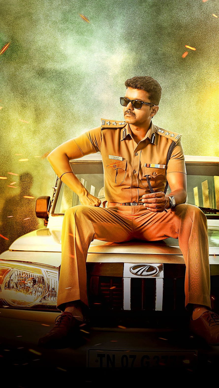 Vijay as Theri in Police Uniform Sitting on Car Hood with Dramatic Smoke Background HD phone wallpaper