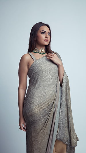 Sonakshi Sinha in a shimmering silver saree with traditional gold and emerald jewelry HD phone wallpaper