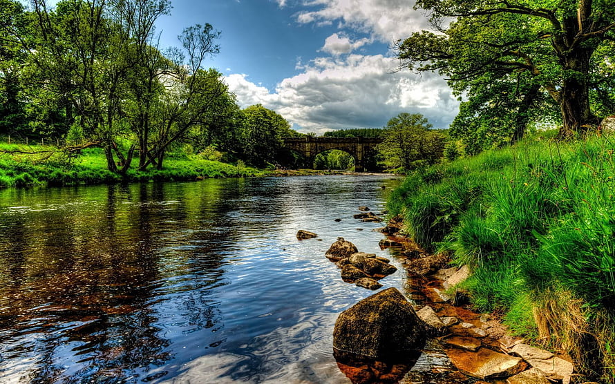 Serene River Landscape With Stone Arch Bridge And Lush Green Banks HD wallpaper