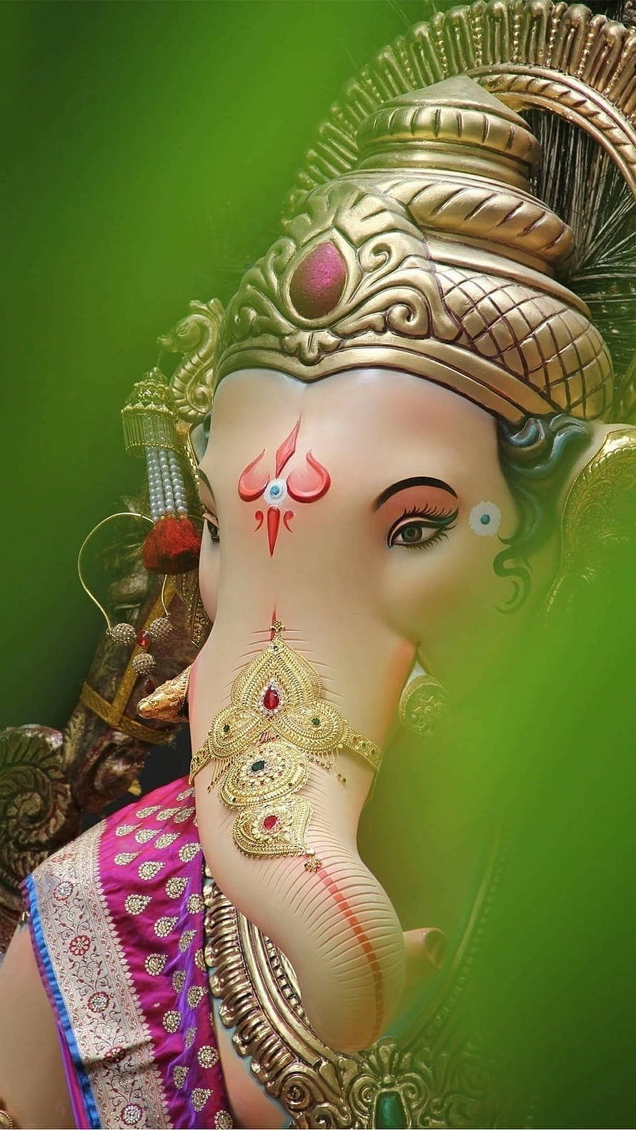 Close-up Portrait of Lord Ganesha with Golden Crown and Trunk Ornament HD phone wallpaper