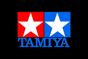 Tamiya Brand Logo Featuring Red and Blue Star Emblems on Black Background HD wallpaper