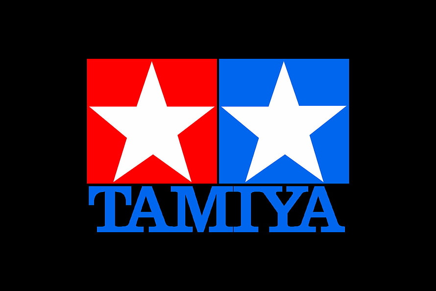Tamiya Brand Logo Featuring Red and Blue Star Emblems on Black Background HD wallpaper