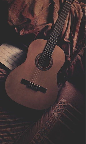 Vintage Acoustic Guitar Resting on Draped Fabric with Sheet Music HD phone wallpaper