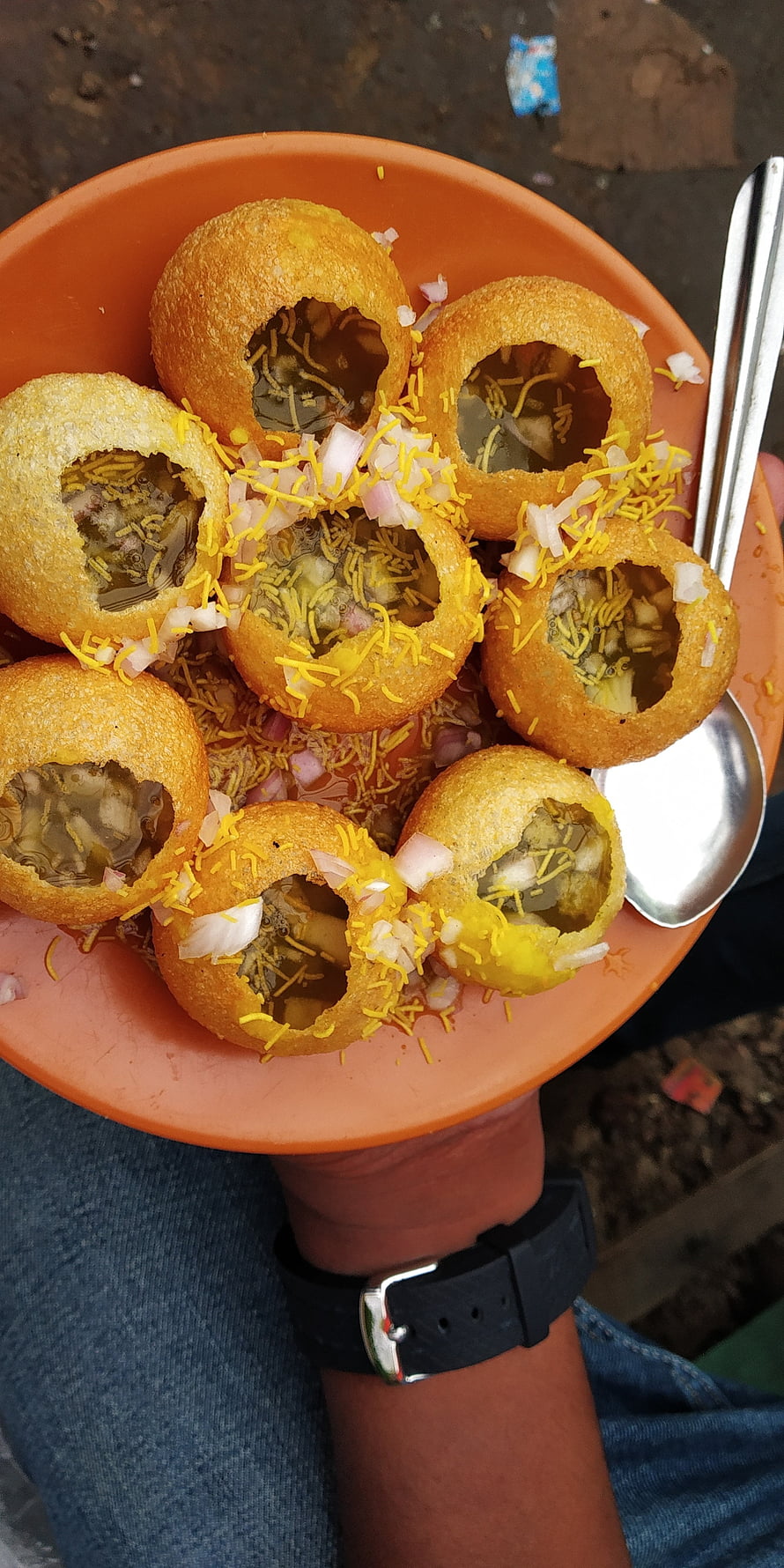 Golden Pani Puri Stuffed With Spicy Water, Onions, And Sev On An Orange Plate HD phone wallpaper