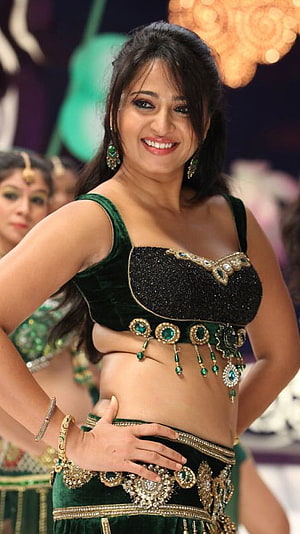 Anushka Shetty in a stunning green velvet traditional dance costume with gold jewelry HD phone wallpaper