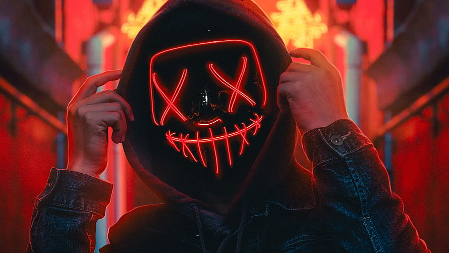 Mysterious Hooded Figure Wearing Glowing Red Neon Mask in Cyberpunk Style HD wallpaper