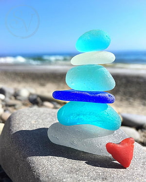 Stacked Sea Glass Sculpture on a Coastal Rock with Ocean Horizon HD phone wallpaper