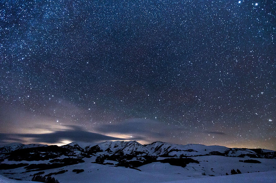 Starry Night Sky Over Snow-Capped Mountain Range in Winter Landscape HD wallpaper