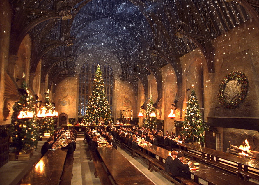 Harry Potter Great Hall Christmas Feast with Snowfall and Decorated Trees HD wallpaper