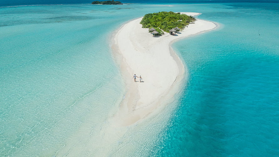 Aerial View of a Pristine Tropical Island in the Maldives with Turquoise Waters HD wallpaper