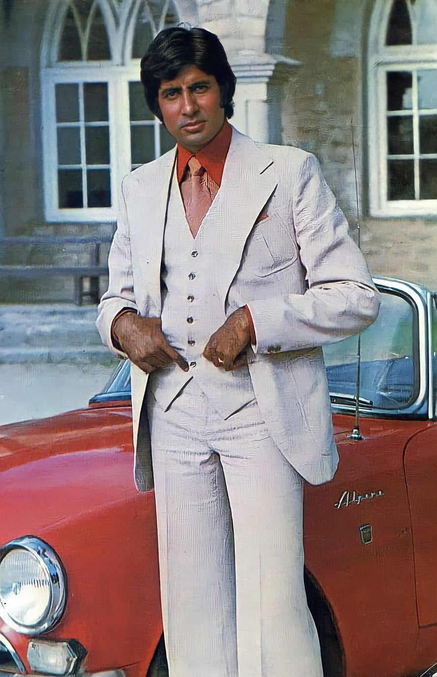 Amitabh Bachchan in a white three-piece suit standing beside a vintage red car HD phone wallpaper