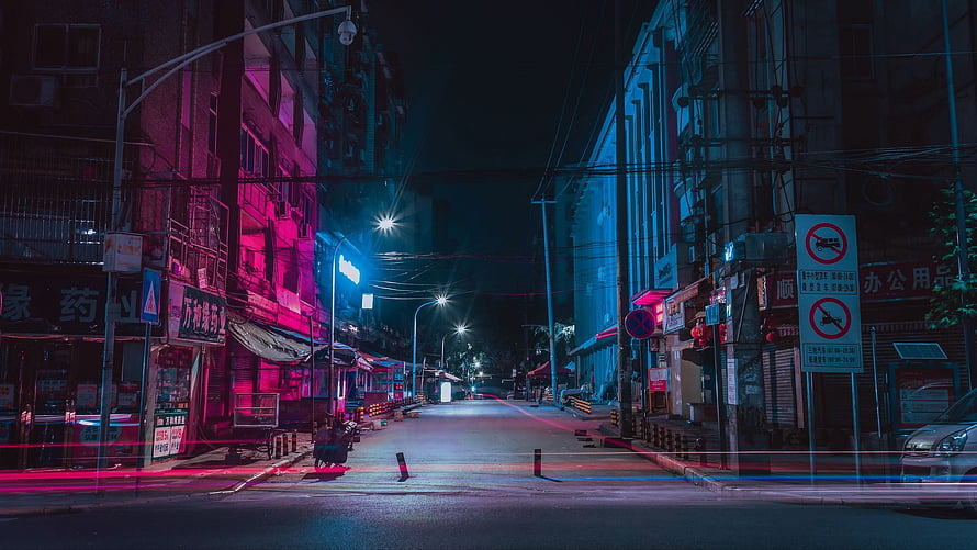 Neon-Lit Urban Street at Night with Cinematic Pink and Blue Lighting HD wallpaper