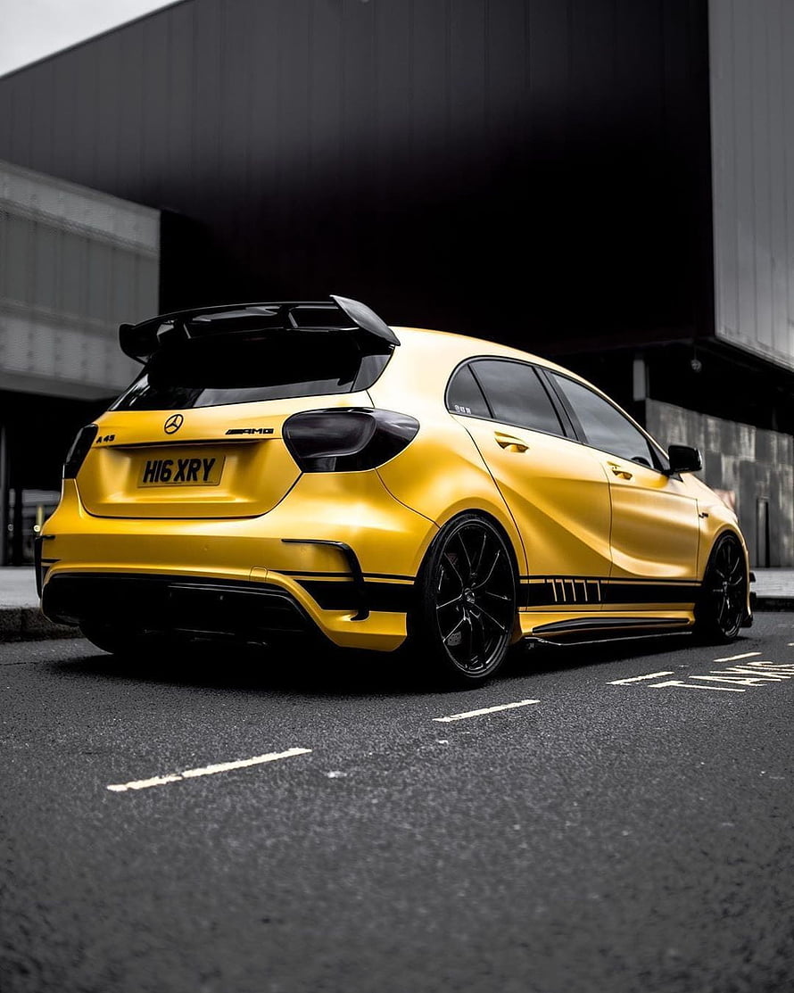 Yellow Mercedes A45 AMG Hatchback with Black Rear Spoiler and Custom Wheels HD phone wallpaper