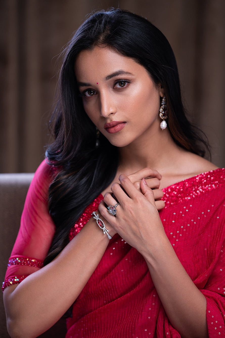 Srinidhi Shetty in a vibrant red sequined sari with elegant diamond jewelry and pearl earrings HD phone wallpaper