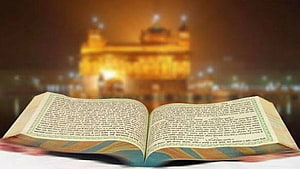 Open Guru Granth Sahib with Golden Temple Silhouette in Warm Evening Light HD wallpaper