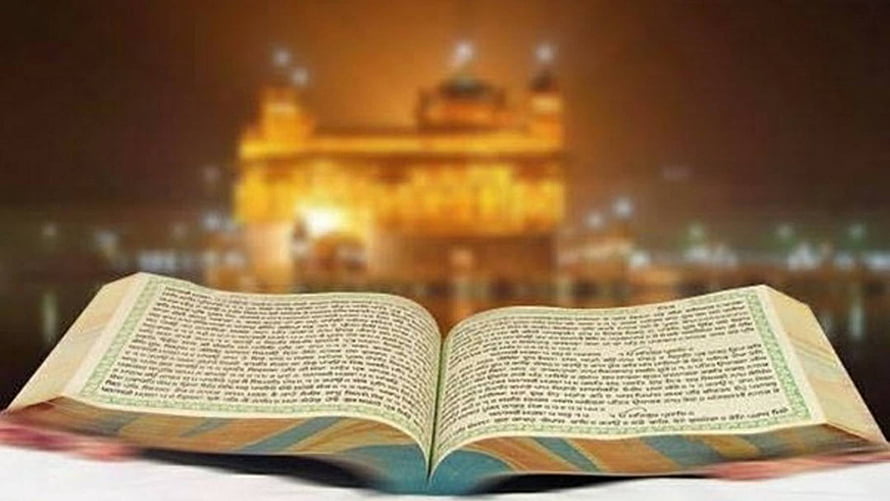 Open Guru Granth Sahib with Golden Temple Silhouette in Warm Evening Light HD wallpaper