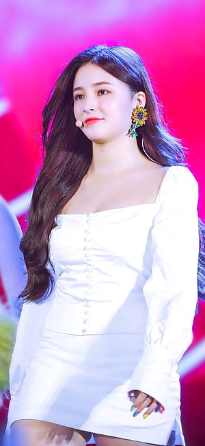 Nancy from Momoland in a white dress on stage with vibrant pink lighting HD phone wallpaper
