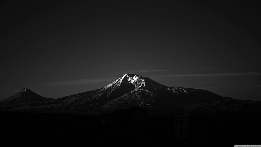 Dramatic Black and White Snow-Capped Mountain Peak at Dusk HD wallpaper