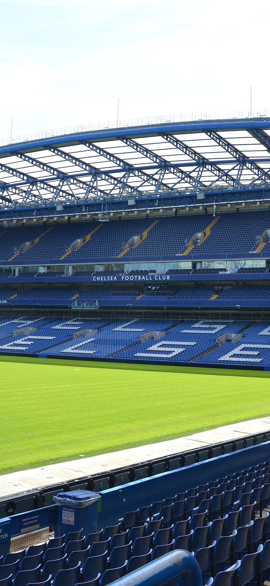 Chelsea Football Club Stadium Interior with Blue Seating and Green Pitch HD phone wallpaper