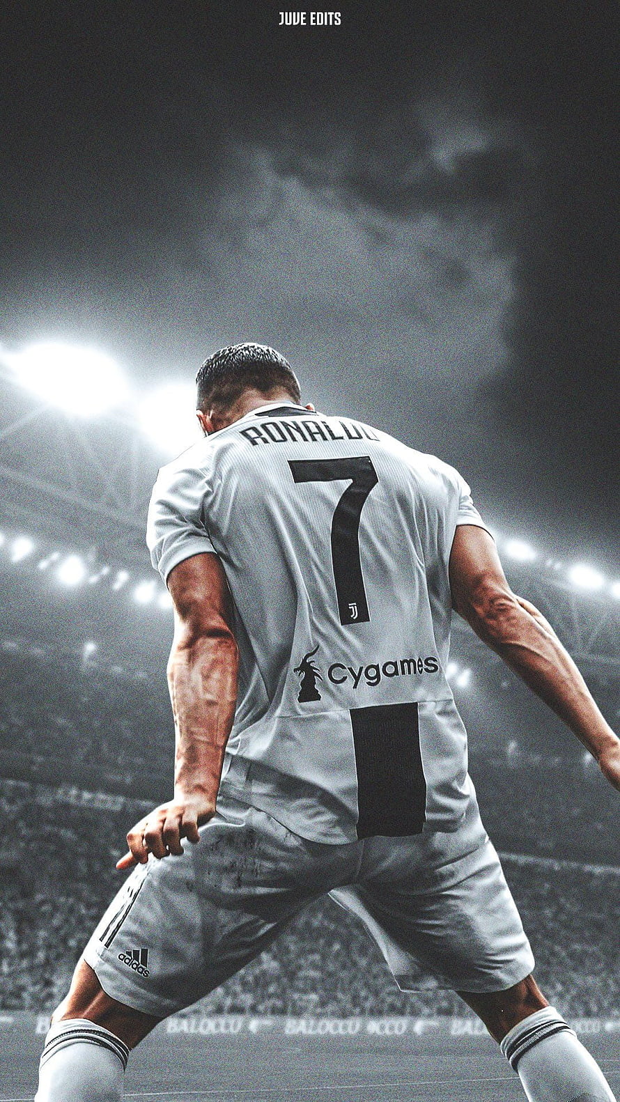 Cristiano Ronaldo in Juventus Kit on the Pitch Under Stadium Lights HD phone wallpaper