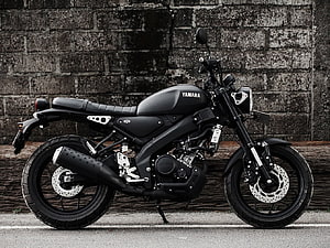 Matte Black Yamaha XSR155 Motorcycle Parked Against Weathered Brick Wall HD wallpaper