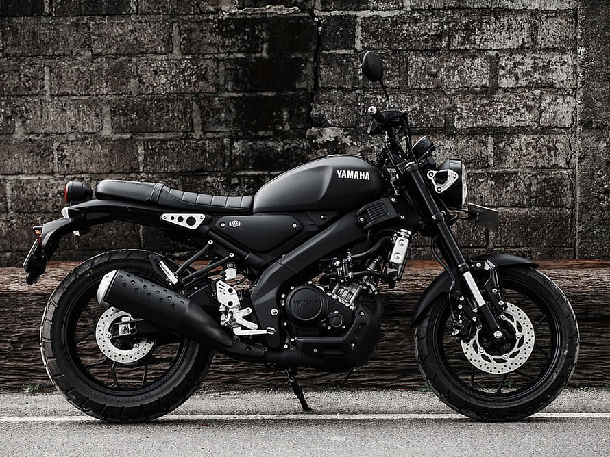 Matte Black Yamaha XSR155 Motorcycle Parked Against Weathered Brick Wall HD wallpaper