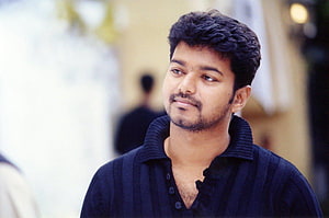 Thalapathy Vijay in a dark polo shirt with a contemplative expression HD wallpaper