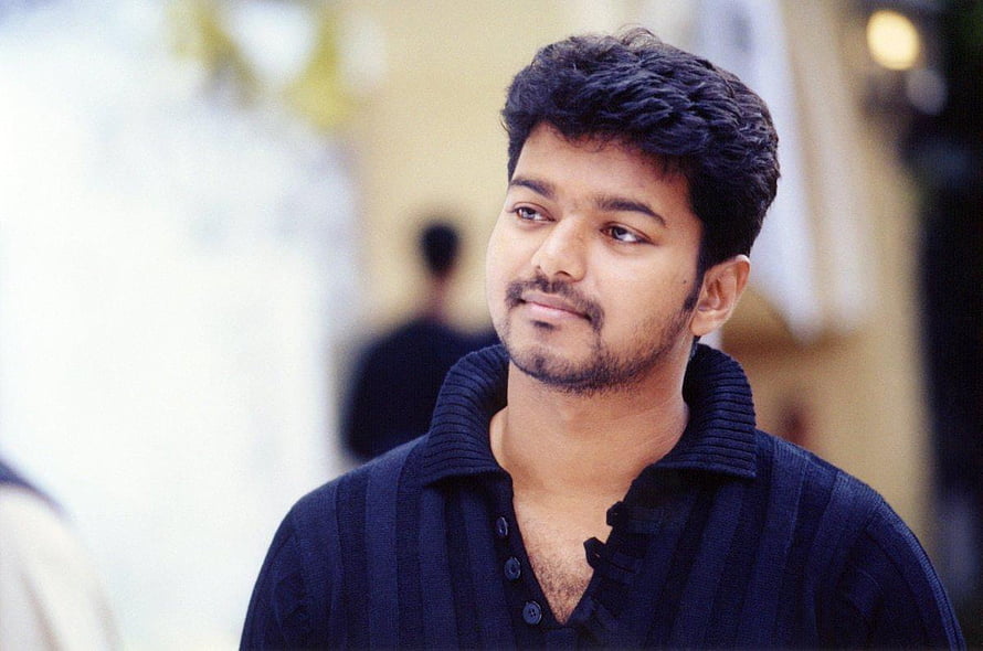Thalapathy Vijay in a dark polo shirt with a contemplative expression HD wallpaper