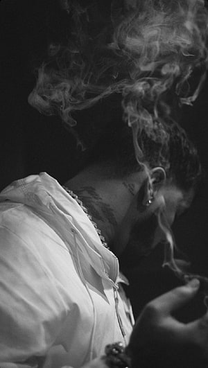 Anuel AA in Black and White Portrait with Billowing Smoke and Neck Tattoo HD phone wallpaper