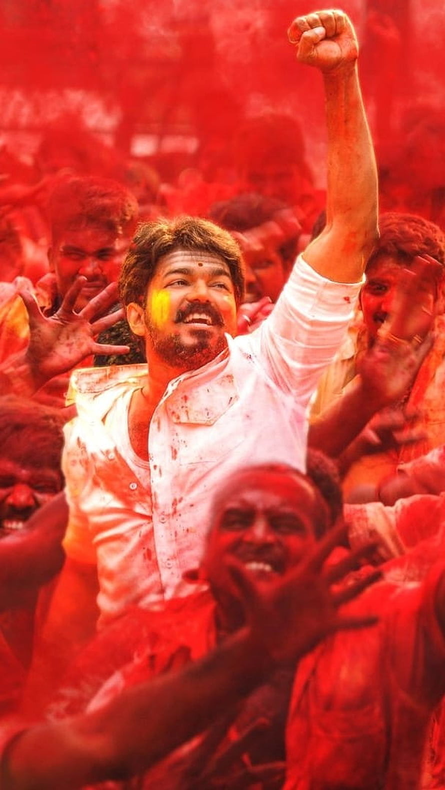 Vijay raising fist in red powder crowd from Thalapathy 65 movie scene HD phone wallpaper