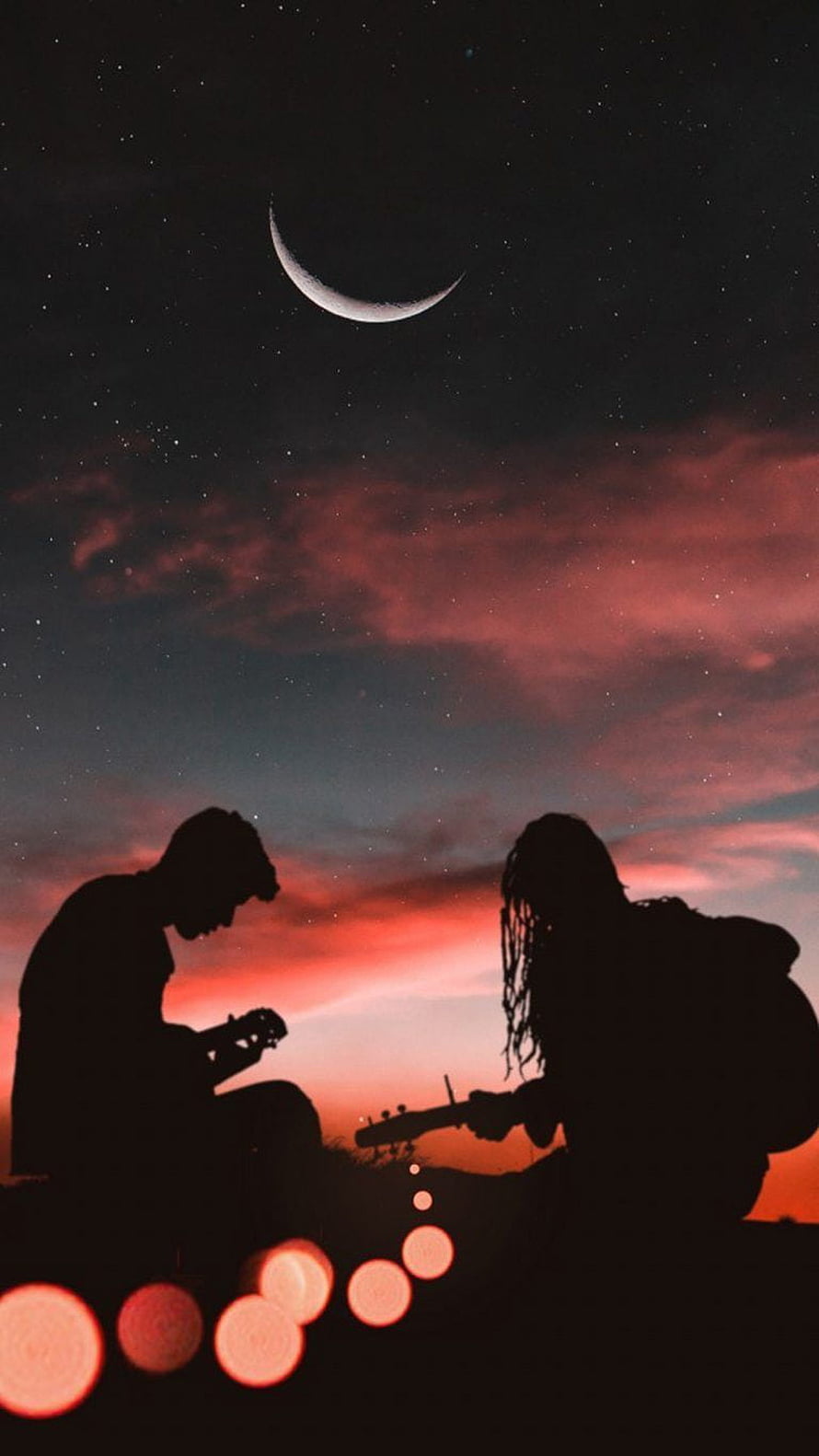 Silhouetted couple playing guitar under a crescent moon and starry twilight sky HD phone wallpaper
