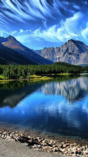 Serene Mountain Lake Reflection with Dramatic Clouds and Pine Forest HD phone wallpaper