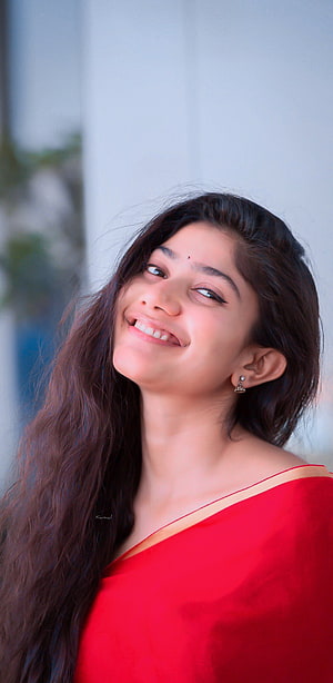 Portrait of a smiling woman with long dark hair wearing a red saree, Sai Pallavi, lip HD phone wallpaper