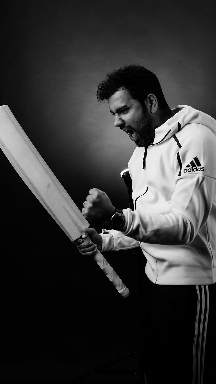 Rohit Sharma Celebrating with Cricket Bat in Black and White Portrait HD phone wallpaper